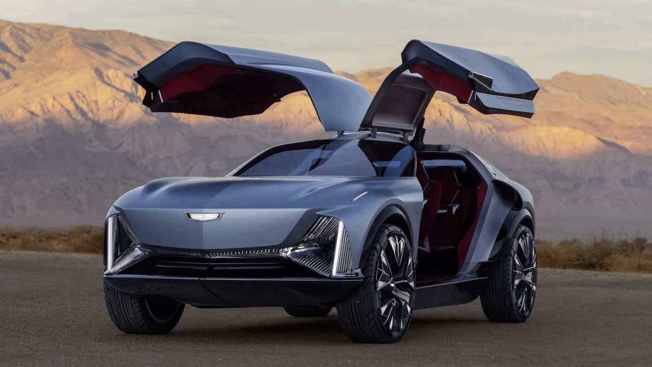 Front 3/4 view of the Cadillac Elevated Velocity concept in Vapor Blue with the gull-wing doors open with the desert in the background.